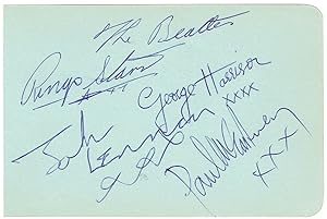 Signed album page by the four members of the Beatles.