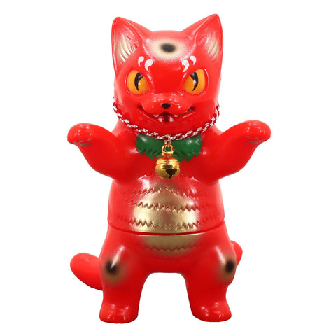 A red kitty cat figurine with yellow eyes, black markings, and green accents wears a chain necklace with a bell. The Konatsuya (JP) Negora — Red Lucky Cat stands upright with its front paws raised.