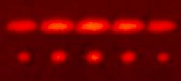 Red light diffracted by two slits (top) and by five slits (bottom)