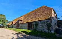 The medieval tithe barn at Alciston, East Sussex, England. September 2024.