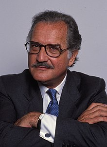 Head photo of a greying man with a small moustache.