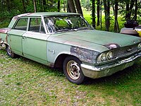 A weathered Ford 300 4-Door Sedan. In the absence of a front fender badge, this vehicle likely came equipped with the standard OHV inline-6 engine.