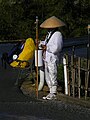 A Buddhist pilgrim asking for alms outside a Buddhist temple.