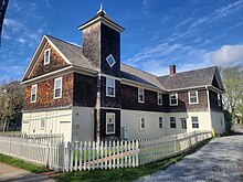 Dia Bridgehampton showing corner of building with picket fence