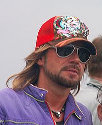 Stephan Weidner—a bearded man with sunglasses, purple jacket and red baseball cap