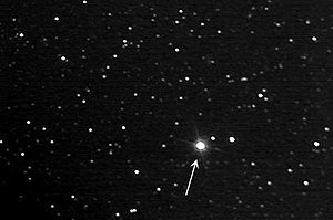 photograph of stars with an arrow pointing to one of them