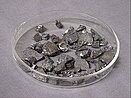 Several dozen small angular stone like shapes, grey with scattered silver flecks and highlights.