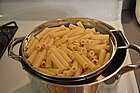 Cut ziti sitting in a strainer