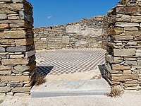 Cubic geometric-patterned floor mosaic in the ruins of a home