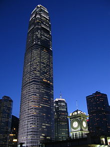 A brightly lit tall skyscraper at night