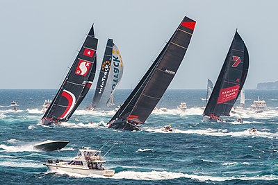 InfoTrack leads the fleet through Sydney Heads and south to Hobart in ideal, if smoky conditions at the start of the 75th Sydney to Hobart Yacht Race in 2019