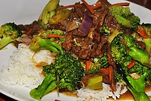 Broccoli beef on a rice bed