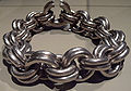 Chain ends linked together by penannular ring to form choker.