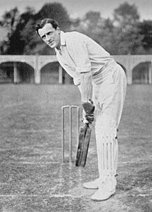 A cricketer in his batting stance.