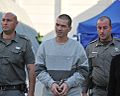 Itzik Abergil, center, escorted by Israeli forces, January 12, 2011