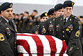 A casket team from the 1st Special Forces Group carry the flag-draped casket of Sergeant 1st Class Nathan R. Chapman on January 8, 2002, at Seattle-Tacoma International Airport.