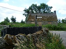 Image of the village of Peaston, a stone cottage and a sign saying 'peaston'.