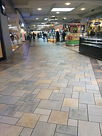 The interior concourse of Castleton Square shopping mall, showing several storefronts