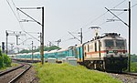 Jammu Tawi bound Humsafar Express leaving Kazipet Junction, hauled by VSKP WAP-7 No. 37062