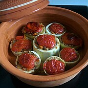 Stuffed zucchini topped with tomato