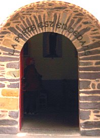 Church door with inscription La porte est en dedans ("The door is within")