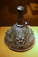 Yoruba 19th century copper alloy (brass) crown from Iperu following the typical Yoruba stem on cone ancestral crown designs. These crowns are used in the veneration of the paternal ancestors of Iperu (Ijebu) kings. The four staring faces represent the all-seeing gods or ancestors. Their protruding eyes signify when the spiritual eye replaces ordinary vision. The two figures with mudfish legs refer to supernatural powers in two realms, land and water, or reality and spirit.