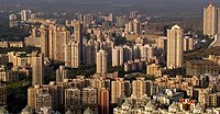 Skyscrapers with carved tops. Smaller buildings on the right side