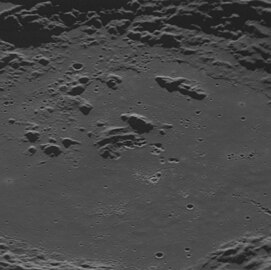 Oblique view of the central crater. Some of the irregular, bright depressions are hollows.