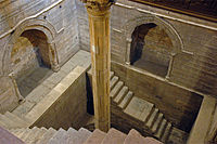 Inside a building, steps leading down in a shaft to measure water level