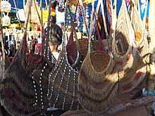 Multicoloured woven bags hanging in a line