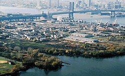 Former Riverside Prison (demolished) and Weeks Marine facilities seen beyond the Benjamin Franklin Bridge