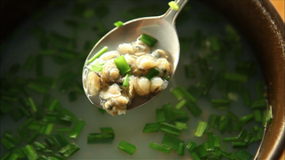 Jaecheop-guk (jaecheop clam soup) with chopped garlic chives in it