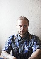 Vincent Pontare in a blue shirt against a white background