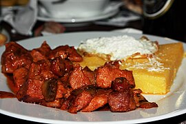 Moldavian tochitură with mămăligă, cheese and egg