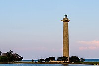 Doric column-shaped tower with trees at its base