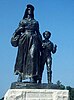 Bronze sculpture of a woman in a sunbonnet leading her son