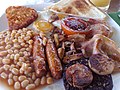 Image 7The full breakfast is among the best known British dishes, consisting of fried egg, sausage, bacon, mushrooms, baked beans, toast, fried tomatoes, and sometimes white or black pudding. (from Culture of the United Kingdom)