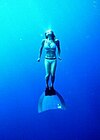 Woman freediving with a monofin