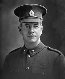 Black and white portrait of a man wearing a military uniform.