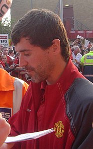 Footballer Roy Keane signing autographs