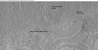 Close-up of lobate debris apron from the previous CTX image of a mesa. Image shows open-cell brain terrain and closed-cell brain terrain, which is more common. Open-cell brain terrain is thought to hold a core of ice. Image is from HiRISE under HiWish program.