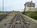 Image 38The "hump" of a hump yard. Railcars travel past retarders, which control their speed, and are directed onto tracks to be assembled into new trains. The control tower operates the retarders. (from Rail yard)