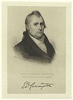 Print shows an unsmiling man in a dark coat with a white shirt. His signature is below.