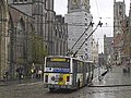 Gentse trolleybus richting Gentbrugge steekt bij de Korenmarkt de bovenleiding van tramlijn 1 over met een speciale constructie. De bovenleiding van de trolleybus is boven het trottoir gehangen in verband met de aanwezigheid van tramlijn 4.