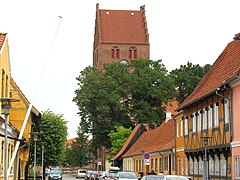 Краєвид на Kirkestræde (церковну вулицю) в Кеге. За деревами - церква Святого Миколая.