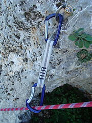 Image of a climbing bolt that is attached to a quickdraw