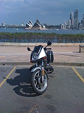 Front view of BMW R65LS motorcycle parked in a car park with the Sydney Opera House visible across the bay