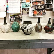 Raku work with crackle glazes (left), copper glazes (right), and pop-off slip (center)