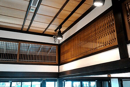 A ranma fanlight, unfilled for air circulation. Note fukiyose, clustered spacing of the laths.[46]