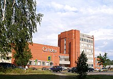 A six-storey office tower and a two-storey warehouse clad in red bricks